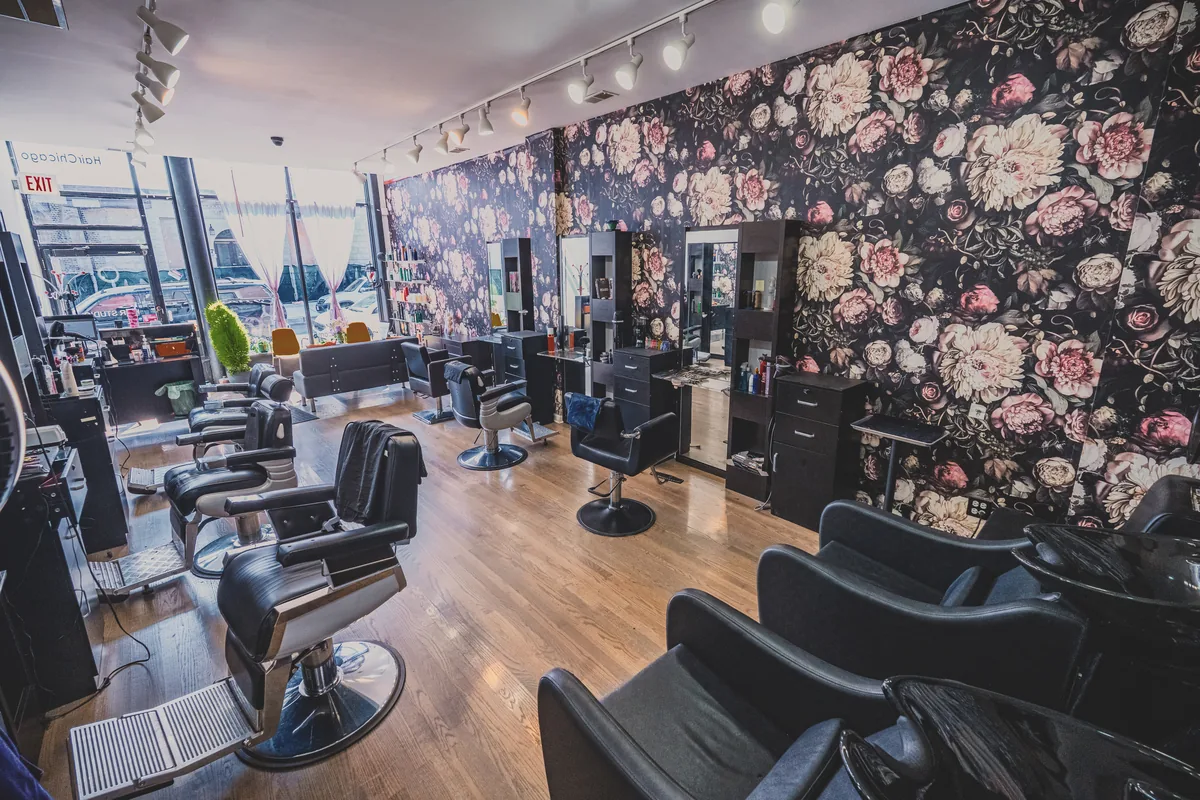 Inside W Hair Studio in Wrigleyville, Chicago — barber chairs and floral wallpaper